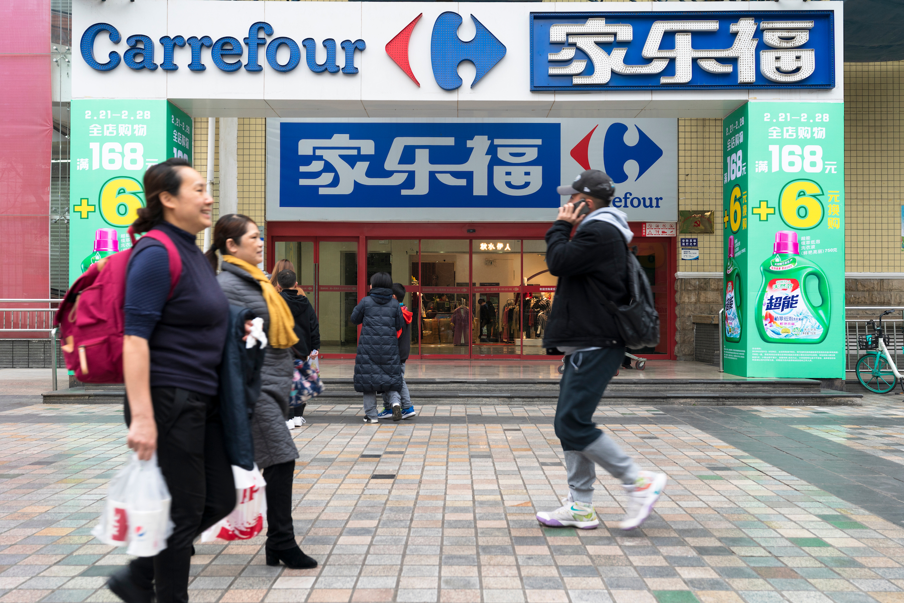 Pedestrians walk past a Carrefour China store